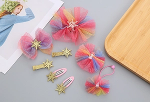 Close-up of pink-purple gradient mesh bows and glitter snowflake clips for girls