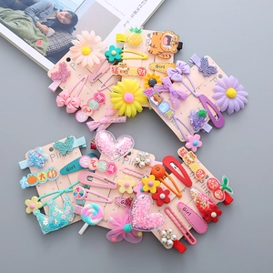 Detail of colorful children hair clip set with floral and bow motifs on display card