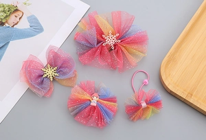 Close-up of girls' hair clip set featuring gradient mesh bows and princess details
