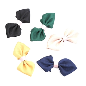 Five-piece set of solid color fabric bow clips in dark green, navy, and yellow tones