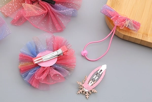 Detail of gradient mesh flower hair clip and pink bow with silver metal duckbill base