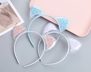 Detail of transparent cat ear headband with colorful star sequins and soft fabric wrap