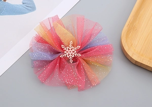 Detail of gradient mesh hair clip with silver glitter and white snowflake ornament