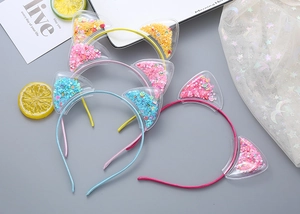 Close-up of colorful cat ear headbands with sparkling sequins and fruit slices filling