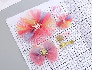 Close-up of rainbow mesh flower and snowflake clips showing dimensions on measurement mat