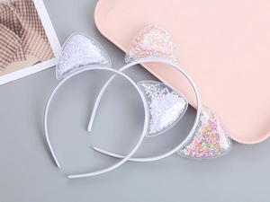 Detail of transparent cat ear headbands filled with colorful glitter and star sequins