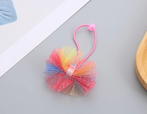 Close-up of kids rainbow gradient tulle hair tie with sparkly silver sequins detail