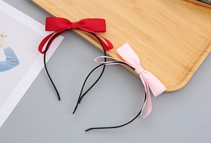 Detailed view of red and pink bow headbands for girls with high-quality textured ribbon