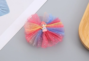 Detail of colorful tulle hair clip with silver sequins and a 3D resin princess character