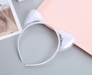 Detail of cute cat ear headband with transparent PVC and silver star sequins inside