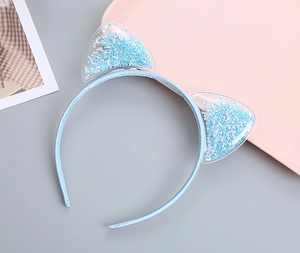 Detail of light blue cat ear headband with flowing silver star sequins inside