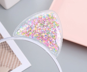 Close-up of cat ear headband featuring transparent PVC filled with colorful glitter stars