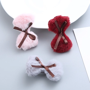 Three plush bow hair clips in pink, burgundy, and gray for girls with ribbon detail