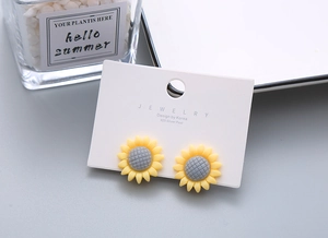 Close-up of cute yellow sunflower resin ear clips with 925 silver needles for girls