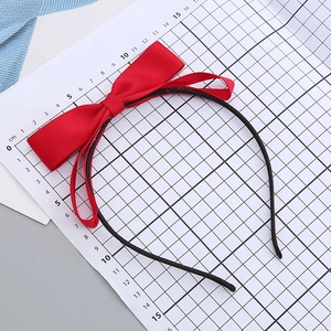 Cute red satin bow headband for girls on a grid background measuring 12-14cm diameter