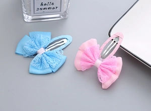 Detail of pink and blue lace ribbon bow hair clips with metal alligator base for girls