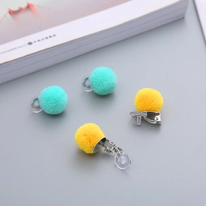Cute candy-colored plush ball clip-on earrings with soft silicone pads for girls