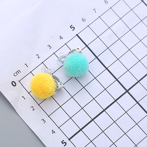 Cute pom pom clip-on earrings in yellow and mint green with soft comfort pads