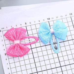 Lace bow hair clip set in pink and blue colors on a measurement board for girls