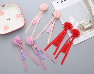Detail of floral hair clips with tassels and pearls for girls summer traditional hair accessories