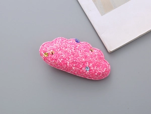 Detailed close-up of a pink glitter cloud hair clip with colorful sparkling sequins