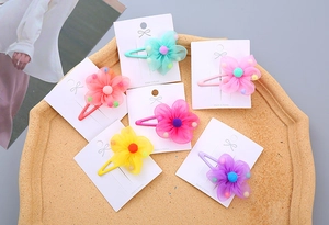 Set of 6 colorful chiffon flower hair clips for girls arranged on a display tray