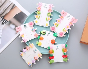 Macro detail of colorful resin flower and fruit hair clip sets on handmade display cards
