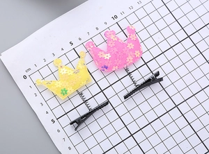 Detail of star crown spring clips with sequins and macaron mesh on measurement board
