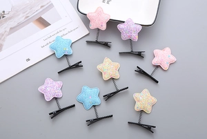 Flat lay of colorful glitter star spring hair clips in macaron colors for kids