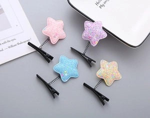 Close-up of colorful glitter star hair clips with metal springs and duckbill clips