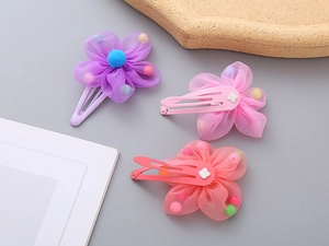 Detailed view of three candy-colored mesh flower hair clips with colorful beads inside