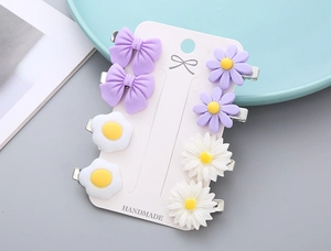 Detailed set of 8 cute floral and bow hair clips on handmade card for girls