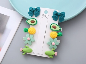 Detail view of 10-piece cute fruit and bow hair clips on handmade display card