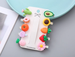 Detailed macro view of 10-piece resin cartoon hair clips on a handmade card