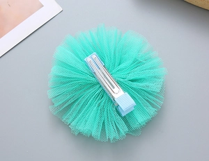 Detail of children's light green tulle flower hair clip with light blue fabric-wrapped clip