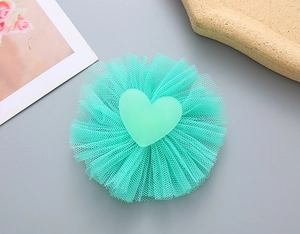 Detailed view of mint green heart hairclip with layered tulle mesh and matte finish heart