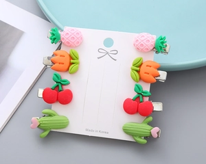 Set of 8 tropical fruit and plant resin hair clips on a white gift card display