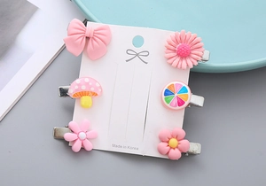 Close-up of 6pcs cute resin flower and bow hair clips on a white display card
