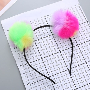 Cute girls headband with colorful rainbow pom-poms for parties and festivals