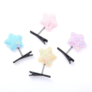 Set of four colorful glitter star spring hair clips in pastel pink blue yellow and purple