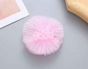 Detail of pink mesh hair clip with a cute resin candy decoration for young girls