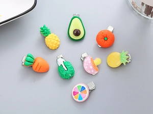 Detail showing 8 colorful resin fruit and vegetable hair clips with metal clips