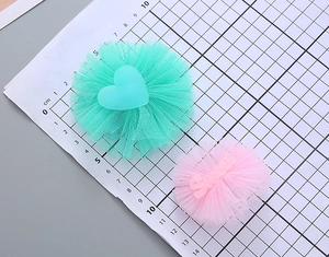 Detailed view of luminous mesh hair clips in mint green and sweet pink colors