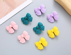 Detailed view of matte pastel bow hair clips for girls in various macaron colors