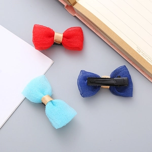 Handmade seersucker bow hair clips in red and blue colors for kids and pets