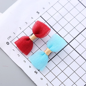 Elegant seersucker mesh bow hair clips in red and blue with gold ribbon accents
