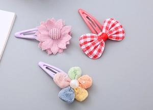Detailed view of 3-piece set featuring fabric flowers, plaid bows, and colorful mesh balls
