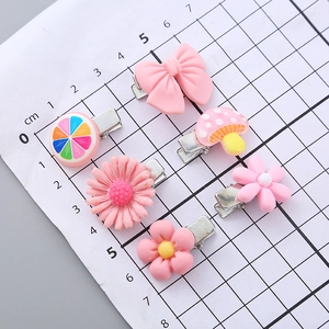 5-piece set of pink candy-colored hair clips featuring flower and bow designs for girls