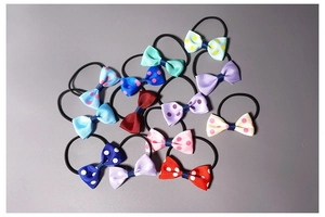 Close-up of assorted colorful floral bow hair ties with elastic bands for little girls