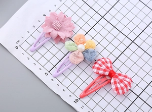 Three-piece hair clip set featuring pink fabric flower, tulle blossom, and plaid bow